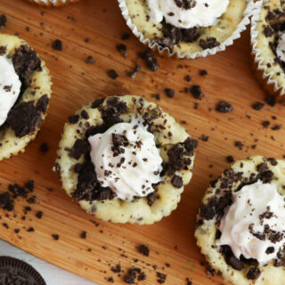 Oreo Cheesecake Bites being served on wooden platter.