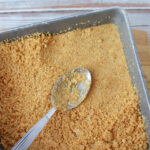 press graham cracker crust into baking pan