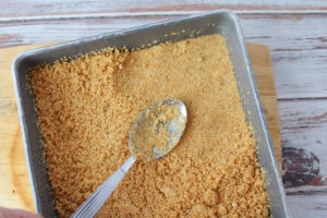 press graham cracker crust into baking pan