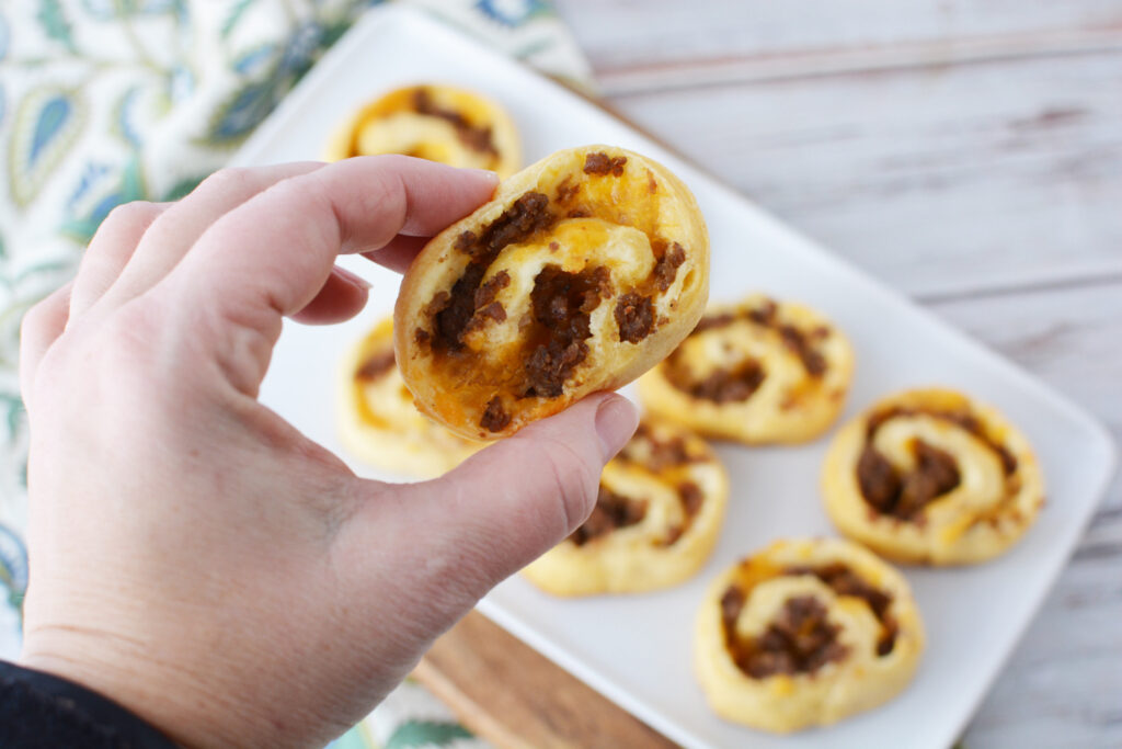 Easy Sausage pinwheels appetizer being eaten