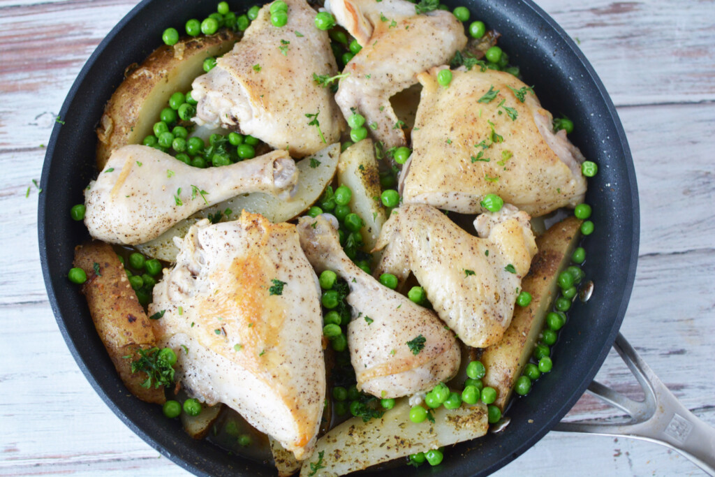 Chicken Vesuvio being baked in a skillet.