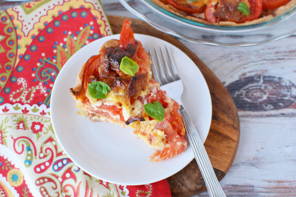 A slice of southern tomato pie on a plate.