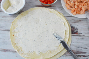 spread cream cheese onto tortilla