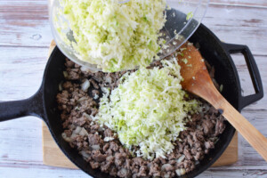 Add cabbage to ground beef.