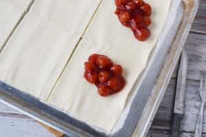 add cherry pie filling to puff pastry.