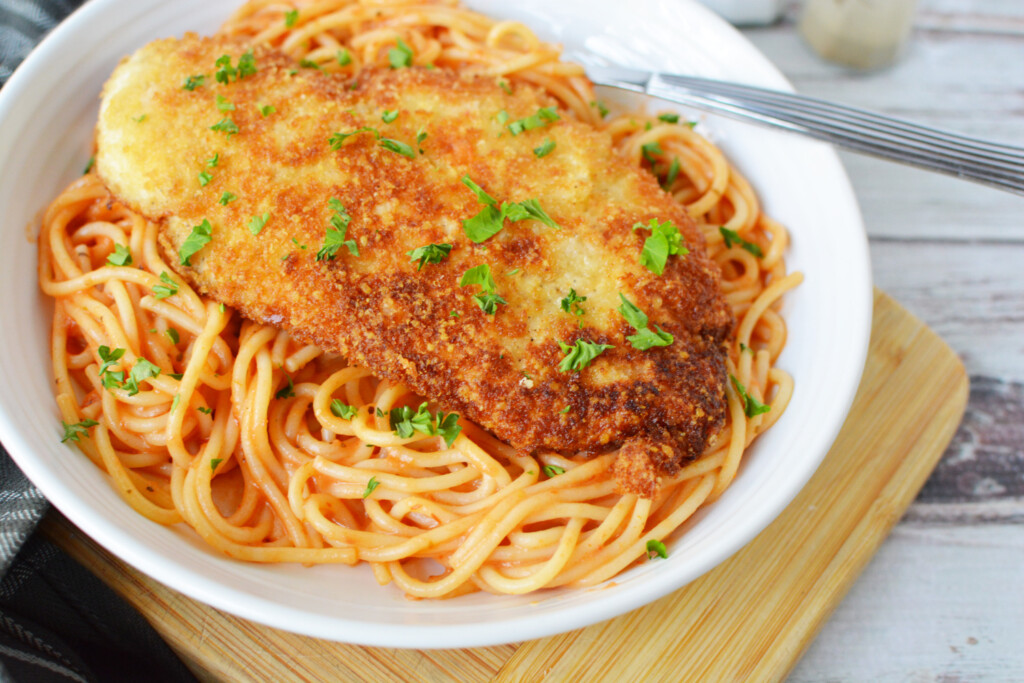 Crusted Chicken Romano on a white plate