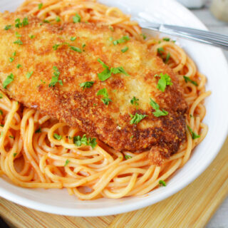 Crusted Chicken Romano on a white plate