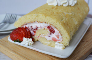 strawberry roll cake served on a white plate
