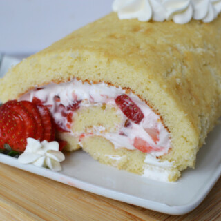 strawberry roll cake served on a white plate