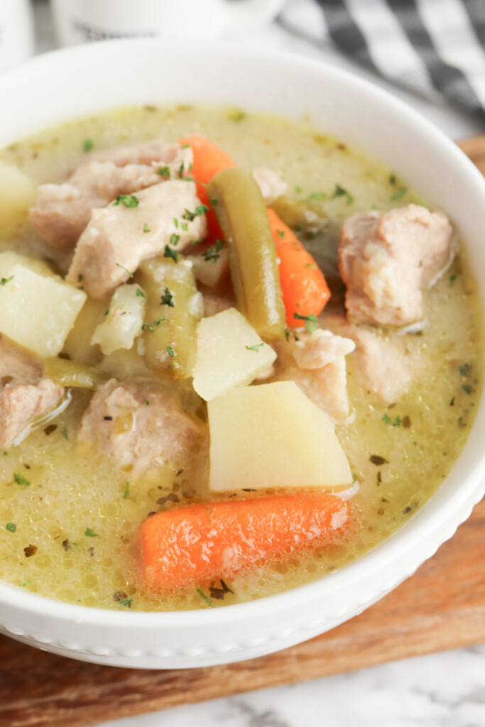 traditional pork stew in a white bowl.